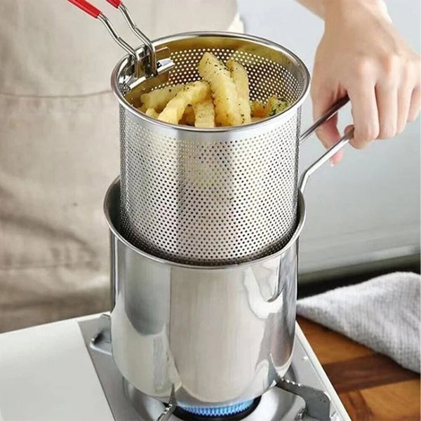 Removable frying basket being lifted from stainless steel pot